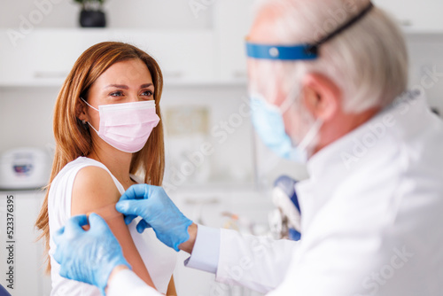 Healthcare specialist applying medical patch to patient after vaccination