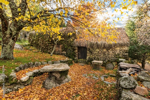 Granit typical rustic old shelter house in the moutains. In the colors of autumn, near river in glaciar valley