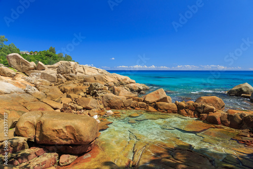Calm rocky coast of the sea with a pool at Machabee Rock Pool - Seychelles