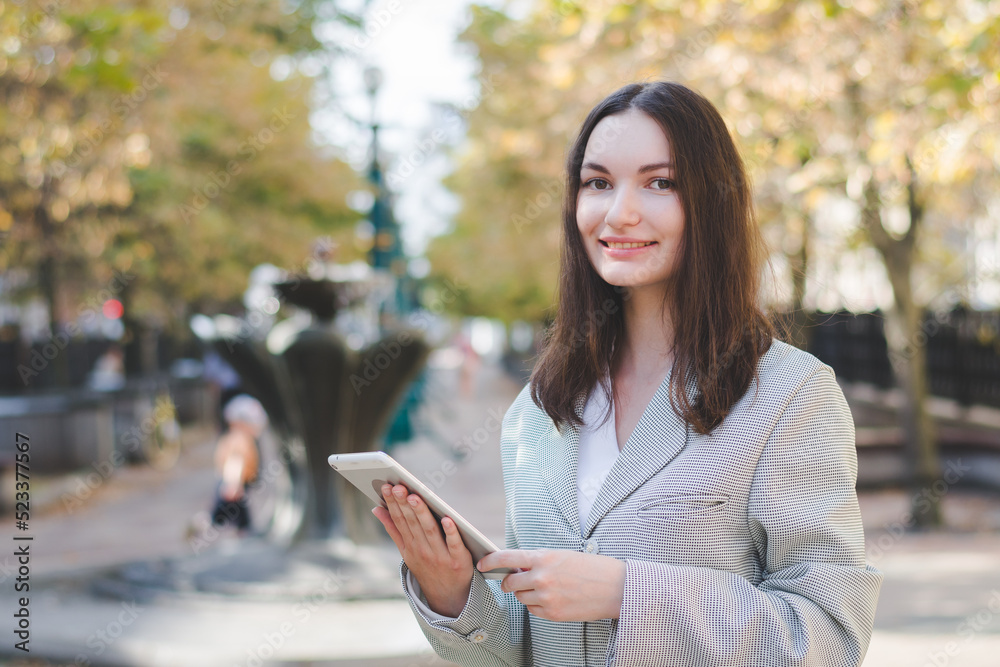 Beautiful white business woman with a tablet in an urban environment Beautiful white business woman with a tablet in an urban environment