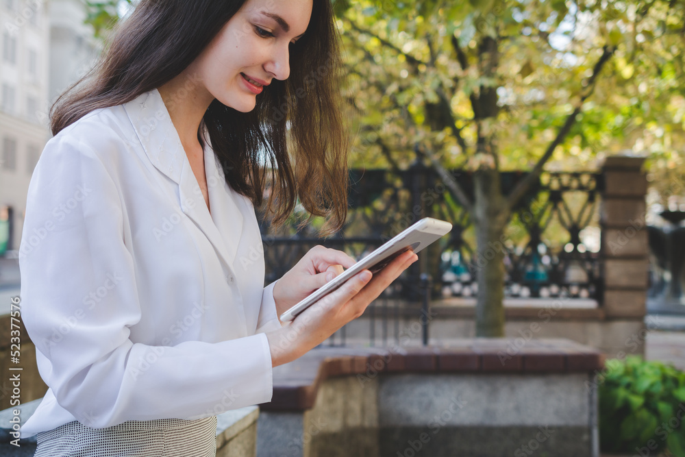 Beautiful white business woman with a tablet in an urban environment Beautiful white business woman with a tablet in an urban environment