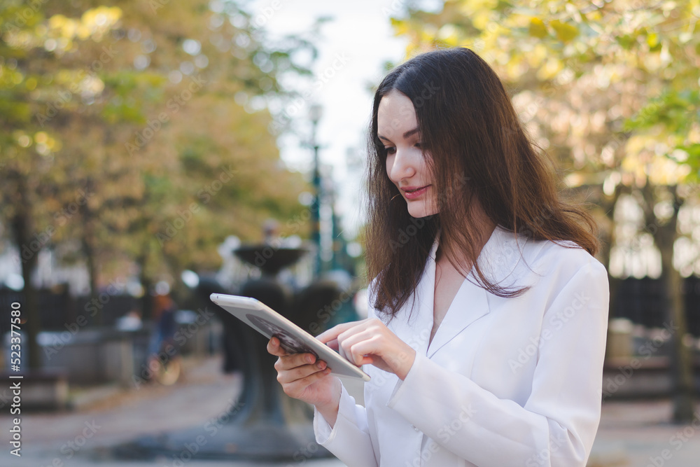 Beautiful white business woman with a tablet in an urban environment Beautiful white business woman with a tablet in an urban environment