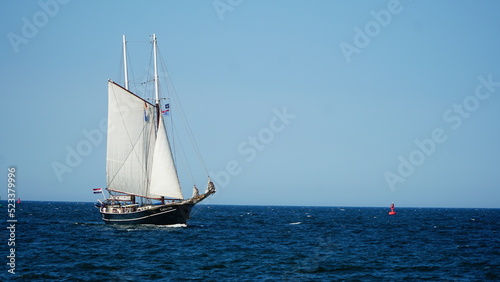 Rostock, Germany - 08.13.2022: Hanse Sail, old sailboat with white sails