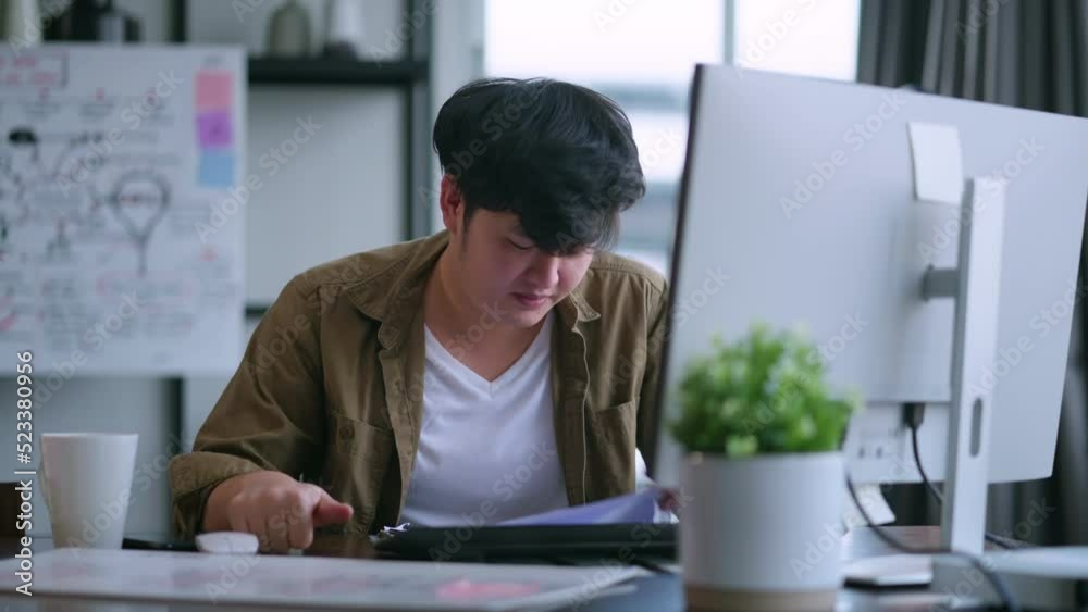 busy work from home asian adult male man planing new project schedule prepare for present to his client while working at home in living room daylight,freelance male relax casual working from home busy work from home asian adult male man planing new project schedule prepare for present to his client while working at home in living room daylight,freelance male relax casual working from home