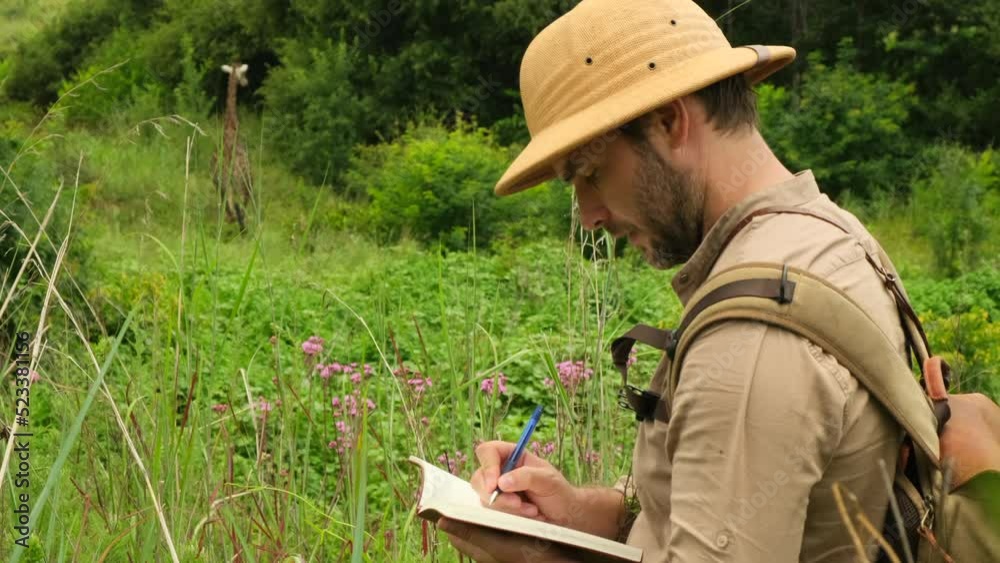 Making check list of things to pack for travel. man writing paper take note to vacation writing paper list. girl tourist in safari clothes takes notes in the savannah about the life of giraffes Making check list of things to pack for travel. man writing paper take note to vacation writing paper list. girl tourist in safari clothes takes notes in the savannah about the life of giraffes