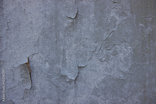 Cracked gray paint on the wall.