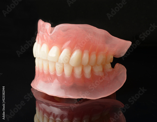 Full denture dentures on black. photo