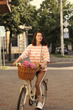 woman with a bicycle in the city on the street