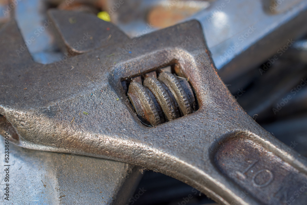 A close-up of a rusty wrench. Screw tightening mechanism of an adjustable wrench for sale at a flea market in Upstate NY A close-up of a rusty wrench. Screw tightening mechanism of an adjustable wrench for sale at a flea market in Upstate NY