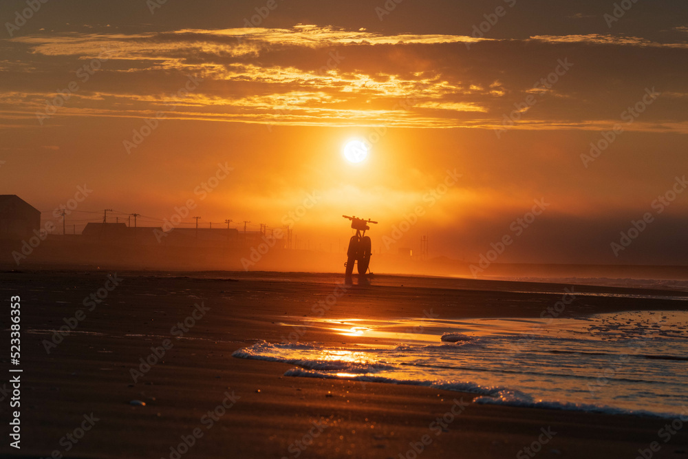 silhouette of a person on the beach at sunset