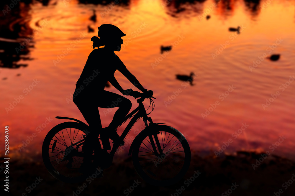 Sports, cycling, silhouette of a girl with a sports figure on a bicycle against the background of a colorful bright sunset and the city. Summer landscape, man and nature, transport. Healthy lifestyle, Sports, cycling, silhouette of a girl with a sports figure on a bicycle against the background of a colorful bright sunset and the city. Summer landscape, man and nature, transport. Healthy lifestyle,