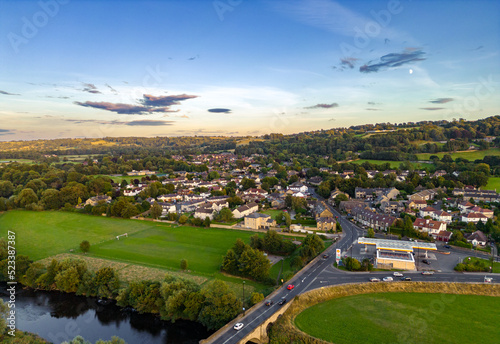 Aerial view of Pool-in-Wharfedale, a village in West Yorkshire, shot from a drone at sunset. 