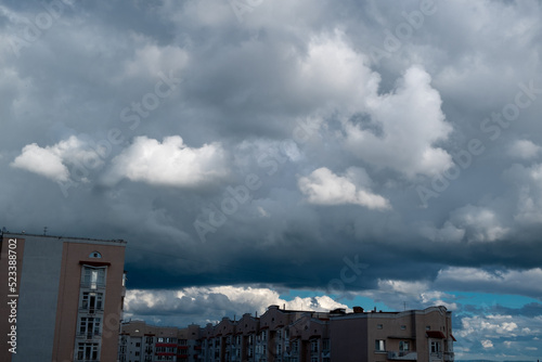 White lush clouds against a bright blue sky. Vertical photo © Yevhenii Khil