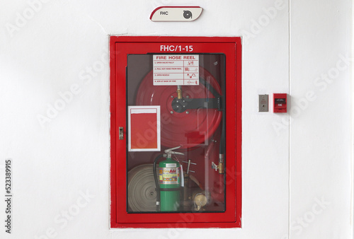 fire extinguisher in front of a wall