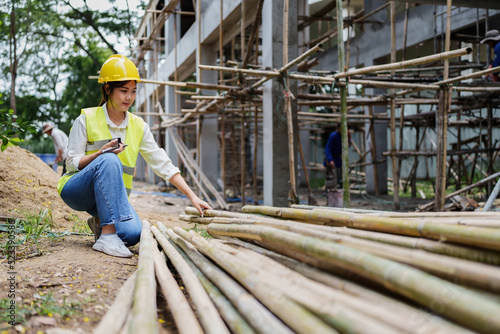 Engineers are checking the quality of bamboo before using at the outdoors construction site