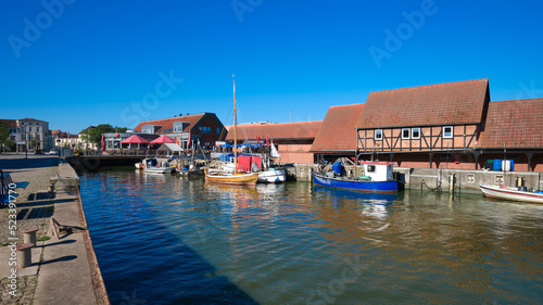 Old warehouses of the Old Hansa Harbor. Fishermen boats with reflection. Wismar is a port and Hanseatic city in Northern Germany on the Baltic Sea