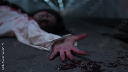 Bloody Hands of woman or murder crime killer on dirty floor or Zombie or ghost horror in the dark background nightmare screaming on hell is monster girl or female dead characters at night. photo