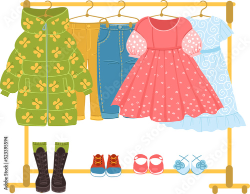 Clothes and shoes storage. Dresses hanging on rack