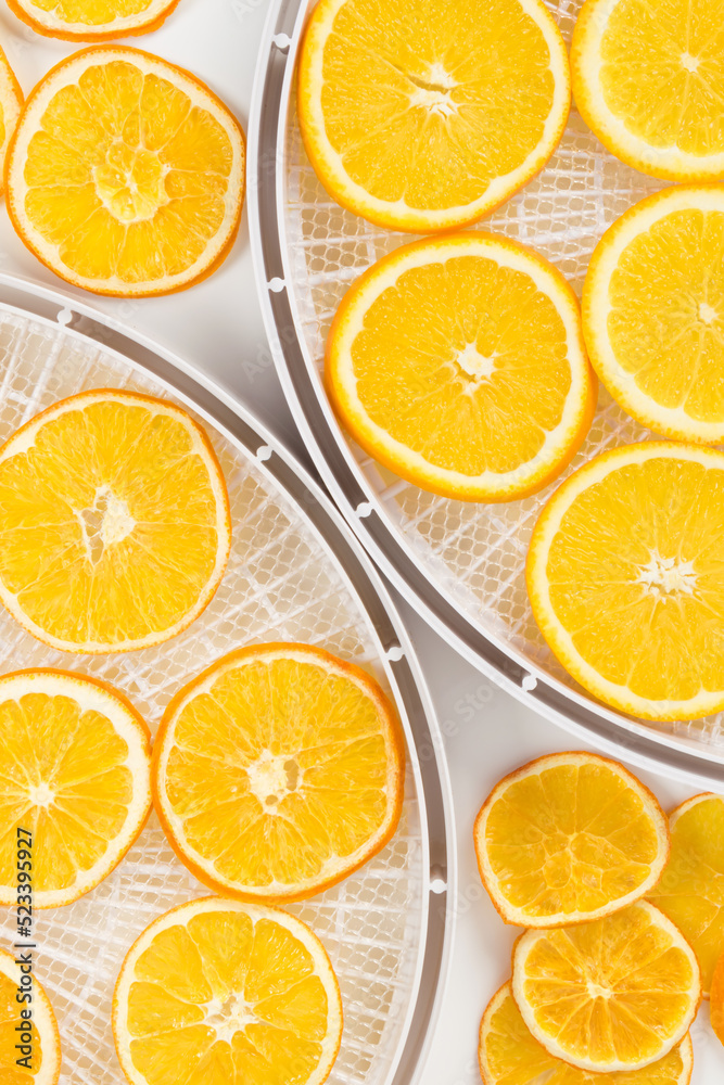 orange slices in a tray for preparing dried fruits, background, top view