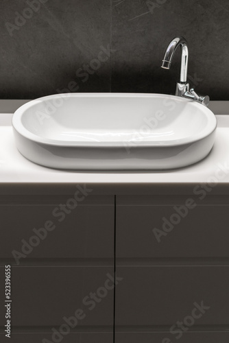 ceramic washbasin and water tap in apartment bathroom