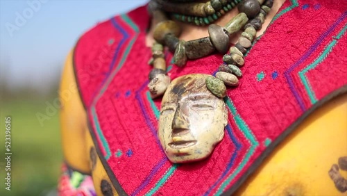 prehispanic aztec textile and necklace close up photo