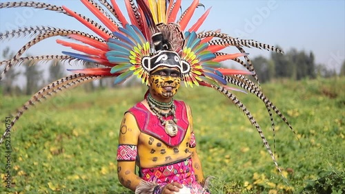 mexican man in prehispanic dancer costume for day of the dead celebration with plume photo