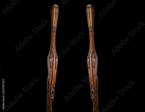 Two wooden sculptures with an astonished look. African art on black background. Background concept.