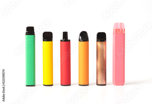 A set of colorful disposable electronic cigarettes of different shapes on a white background. modern smoking.