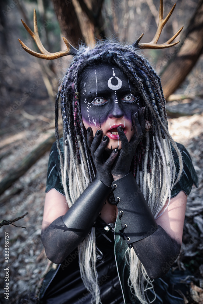 Naklejka premium Forest witch in a pine forest