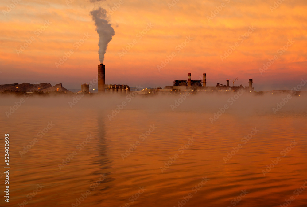 Beautiful sunrise near industrial emissions plant.