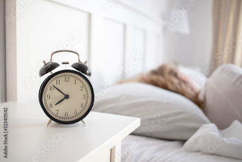 alarm clock and woman sleeping in bed sleep quality
