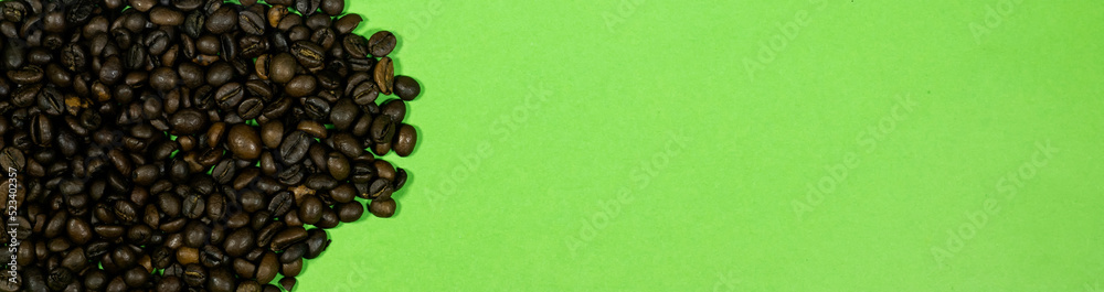 banner Roasted coffee beans isolated on green background banner Roasted coffee beans isolated on green background