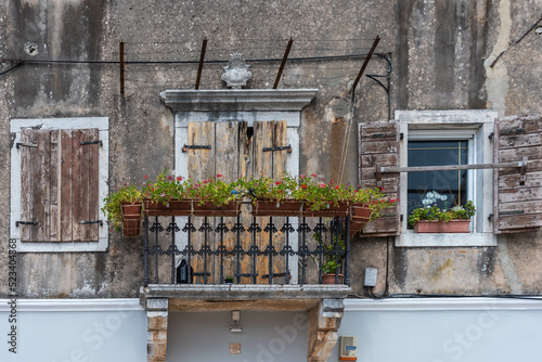 balcony, windows and door of an old house in oprtalj, croatia photo