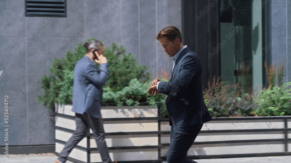 Focused businessman running late on corporate meeting in modern office building. Focused businessman running late on corporate meeting in modern office building.