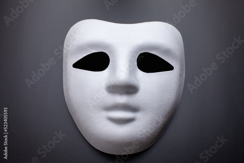 white carnival mask on black background