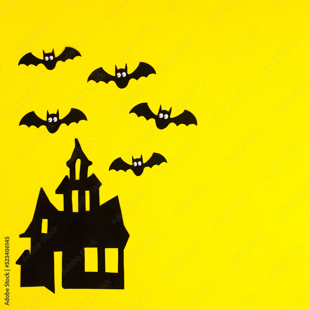 Creepy Horor house with bats on yellow background. Halloween holidays copy space background. Flat lay