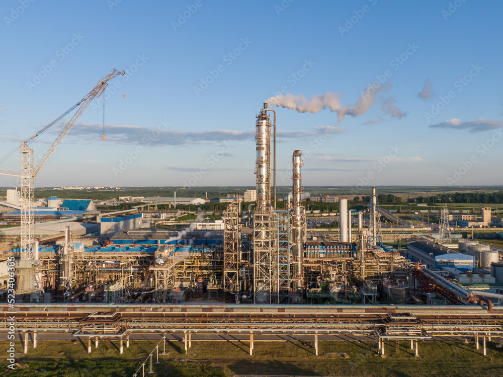 Aerial view of high fractional column in chemical plant. Aerial view of high fractional column in chemical plant.