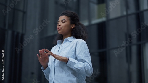 Focused worker meditating at office building closeup. Calm businesswoman relax