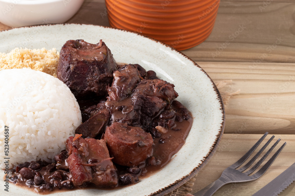 Selective focus on Brazilian feijoada plate. Selective focus on Brazilian feijoada plate.