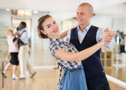 Obraz na plátně Happy man and woman enjoying ballroom dancing