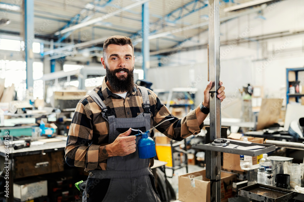 An industry worker checking on bus construction in vehicle production factory. An industry worker checking on bus construction in vehicle production factory.