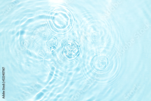 Closeup of blue water surface texture with splashes and bubbles