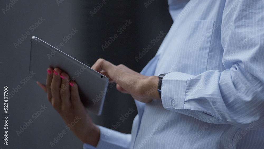 Female hands touching pad screen outdoors closeup. Businesswoman work remotely.