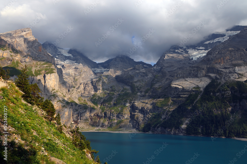 Fototapeta premium Panoramic summer view of the Oeschinensee (Oeschinen lake) and the alps on the other side near Kandersteg, Berner Oberland, Switzerland, Europe
