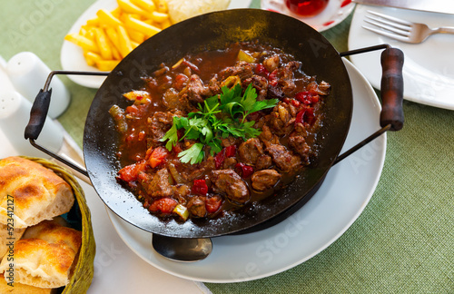 Meat saute in traditional pan - Sac kavurma. Turkish food