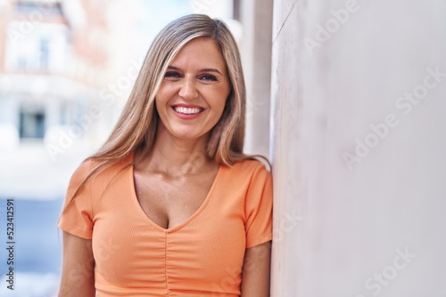 Young blonde woman smiling confident standing at street Free Download Young blonde woman smiling confident standing at street - GFXLoad