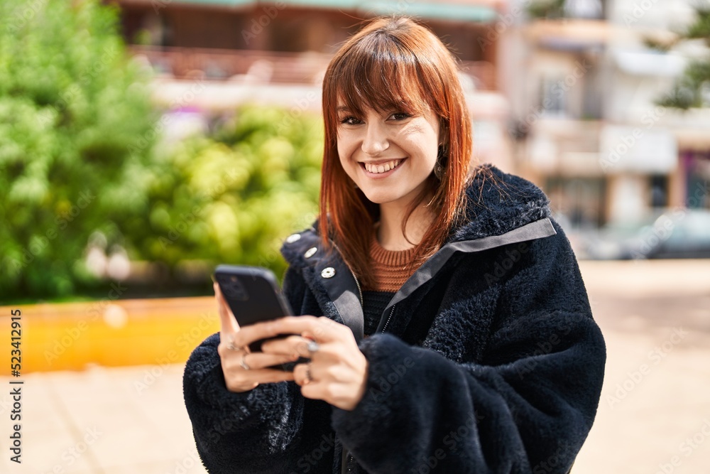 Young woman smiling confident using smartphone at park