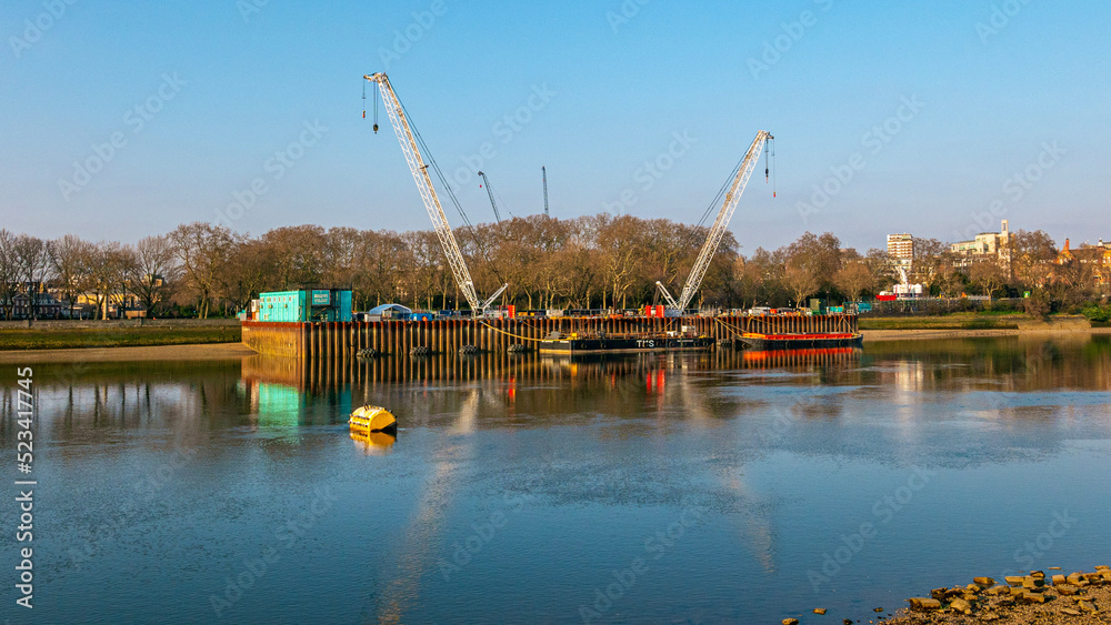 Industrial cranes on the River Thames in London Industrial cranes on the River Thames in London