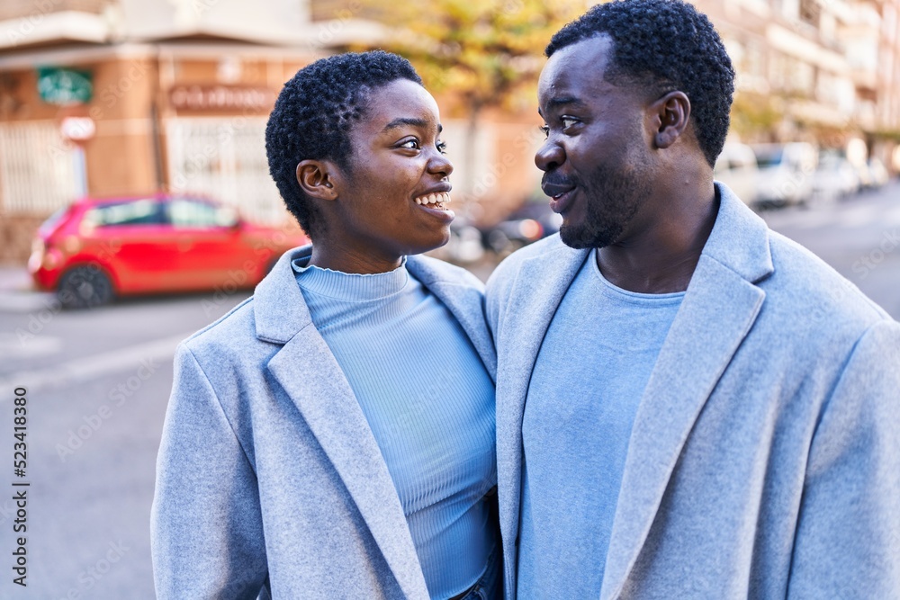 Man and woman couple smiling confident standing together at street