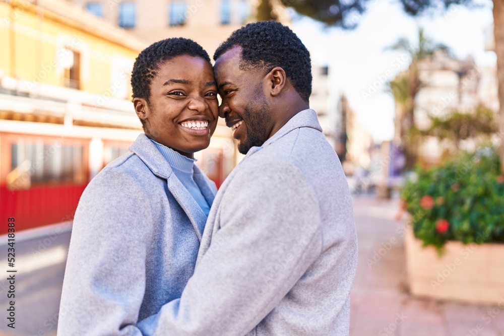 Man and woman couple hugging each other standing at street Man and woman couple hugging each other standing at street